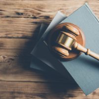 wooden judge on books on the desk wooden judge on books on the desk