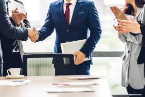 Image two business partners in elegant suit successful handshake