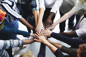 Diversity teamwork with joined hands